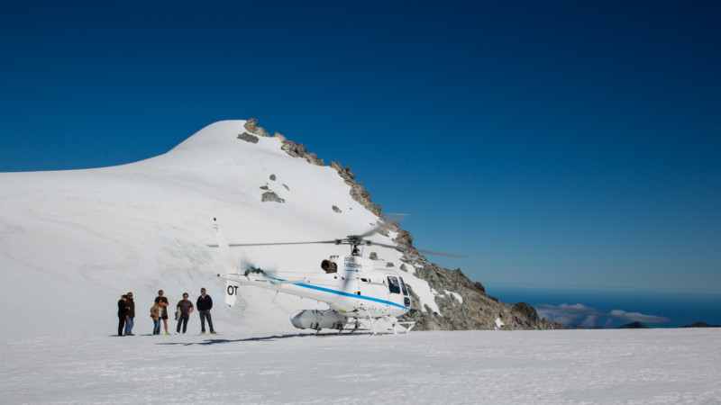 Fly across the clear blue waters of Lake Wanaka, cross over the Southern Alps main divide where you will see the soaring high peaks of Mount Aspiring National Park and multiple spectacular glaciers above native NZ forest.